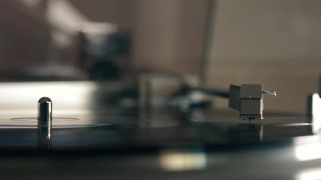 A closeup shot of a vinyl record spinning on a vintage record player in 4k.