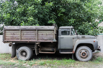 Obraz premium Old rusted soviet truck near the fence