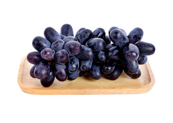 Black grapes  in wood plate on white background