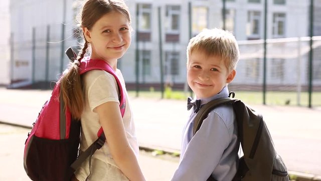  Portraits of children in the background of the school. Funny children. Sister and brother. 
