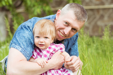 Daddy hugs his little daughter. Family portrait