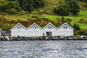 The landscape of cottages on a rock among the greenery off the coast of Norway