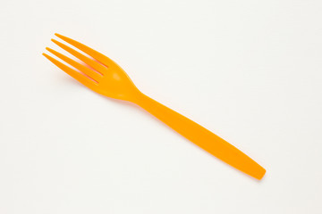 Orange fork on white canvas background.