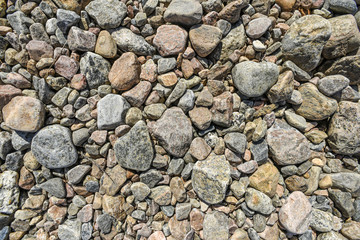 Textures of stones in different colors lying on the ground