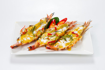Three Pieces of Big Shrimps with Panang Curry Thai Style on White Porcelain Square Plate, Isolated on White Background with Shadow. High Angle Front Side View, Selective Focus at Food.