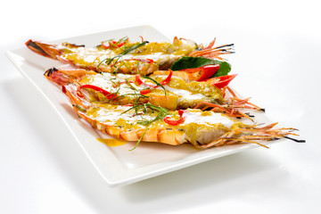 Three Pieces of Big Prawns with Panang Curry Thai Style on White Porcelain Square Plate, Isolated on White Background with Shadow. Close-up Low Angle Front Side View, Selective Focus at Food.