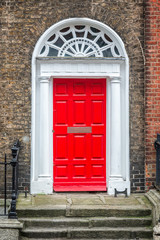 Red classic door in Dublin, example of georgian typical architecture of Dublin, Ireland