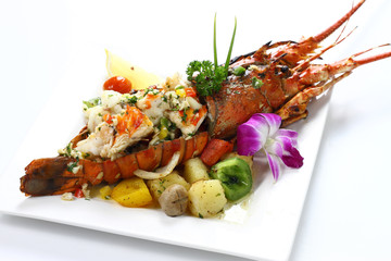 Stir-fried Lobster with Garlic & Butter Sauce on white square porcelain plate Isolated on white background with shadow Top Side view, Expensive Seafood. Selective Focus at Meat