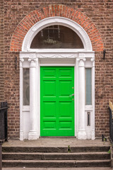 Fototapeta na wymiar Green classic door in Dublin, example of georgian typical architecture of Dublin, Ireland