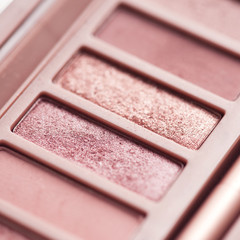 Used eye shadow palette with rose gold colors closeup. Makeup product. Selective focus.