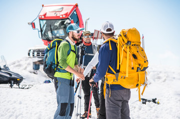 A team of climbers led by a guide discusses the upcoming ascent