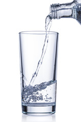 Flowing pure water into glass on white background