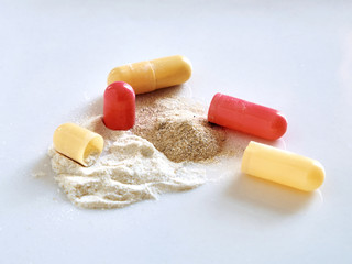 Powder inside opened red yellow pills