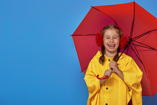 child with red umbrella