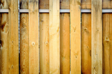 Fragment of a wooden brown modern fence close-up. Wood texture. Modern Style Design wooden Fence Ideas. Front view.