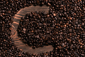 Letter C inscription with coffee bean on the wooden table