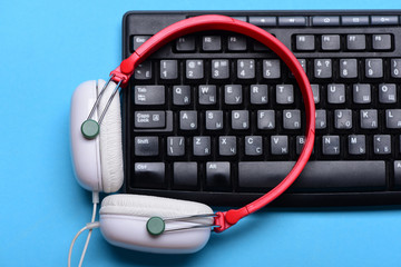 Music and digital equipment concept. Headphones and black keyboard