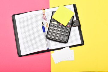 Office tools isolated on yellow and pink background