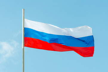 Fototapeta na wymiar Russia flag. Waving colorful Russia flag on blue sky