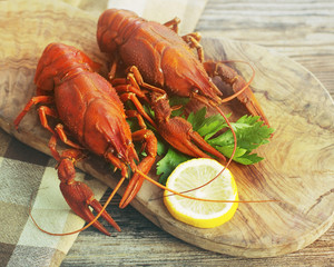 Boiled crayfish on a wooden board, close up