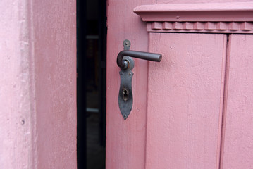 closeup of red door with old doorhandle