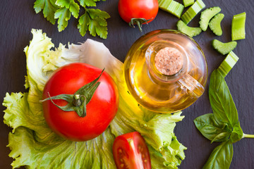 Olive oil, tomatoes and salad leaves