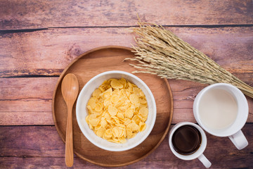 Time to breakfast with milk, coffee and corn flakes