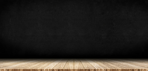 Wood plank table top at black board stone wall background,Mock up for display or montage of product,Banner or header for advertise on social media
