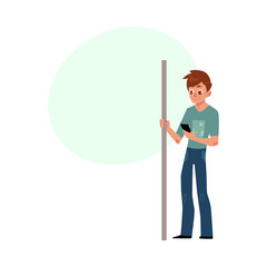 Young man, student, teenager travelling by subway, standing, holding handrail, using phone, cartoon vector illustration with space for text. Full length portrait of young man in subway, bus