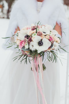 Wedding bouquet in hands of the bride