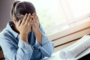 Close-up of architect female stressed and under pressure in the office