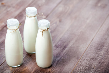 bottles of milk on a wooden rustic table. copy space