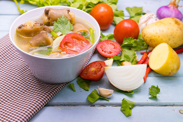 Oxtail soup in white dish on blue  table, Delicious halal food