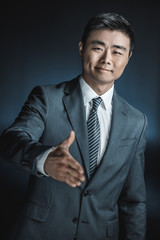 asian businessman outstretching hand