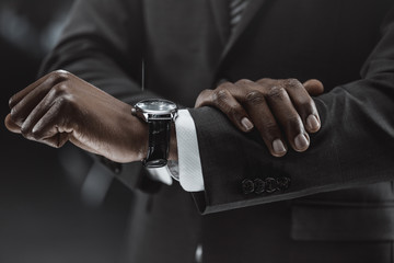 african american businessman checking time