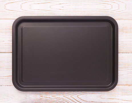 Empty baking tray for pizza on wooden table isolated close up top view square. Mock up for design