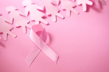 The Sweet pink ribbon shape with girl paper doll on pink background  for Breast Cancer Awareness symbol to promote  in october month campaign