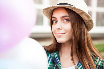 Happy girl with balloons smile into the camera