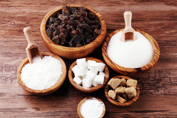 Sugar composition with white and brown sugar on wooden board