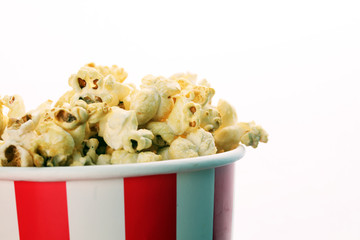 Popcorn in a striped box. Movie eating in theater