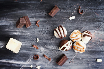 White and Dark Chocolate truffles for Christmas or Valentines's Day with chocolate bark and shavings around them.