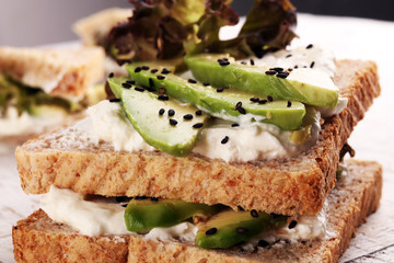 Sandwich with avocado and sesame - healthy breakfast concept