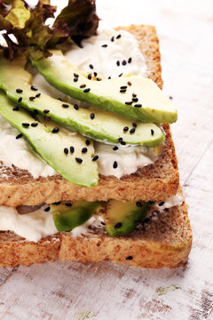 Sandwich with avocado and sesame - healthy breakfast concept