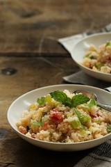 Tabbouleh Salad - Popular vegetarian Mediterranean dish made of fresh cucumber,tomatoes,parsley and coucous