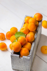 Fresh juicy apricots on a wooden table