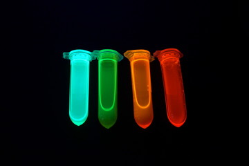 Plastic tubes with quantum dots of perovskite nanocrystals glowing in the dark due to ultraviolet radiation