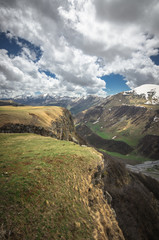 Scenic view on Caucasus mountains in Georgia. A small river flows down the gorge