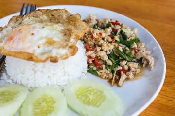 Rice topped with stir-fried pork and basil with fried egg