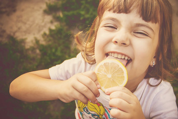 Child with a lemon. Selective focus. 