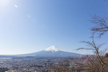 Obraz premium Fuji mountain with blue sky and len flares on up left
